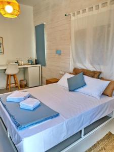a bedroom with a bed with two towels on it at Sea and Sand in Elafonisos