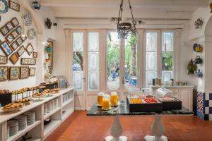 a kitchen with a buffet of food on a table at Hotel Medium Renaixença in Sitges