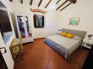 1 dormitorio con cama, mesa y espejo en La Casina di Susy, en Seravezza