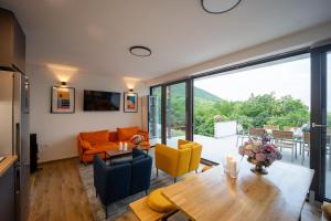 a living room with a table and yellow chairs at Copanjek Country House in Plešivica