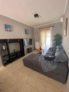 a bedroom with a large bed and a television at nikol_house in Alepou