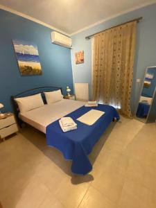 a blue bedroom with a bed with a blue table at nikol_house in Alepou