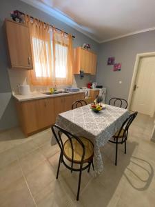 a kitchen with a table with chairs and a table and a table at nikol_house in Alepou