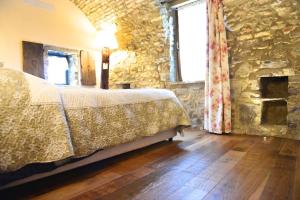 Rúm í herbergi á Agriturismo C'era Una Volta