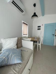 a living room with a couch and a table at Riva House Tribunj in Tribunj