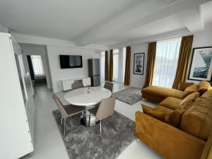 a living room with a couch and a table at Oxygen Residence Neptun in Neptun