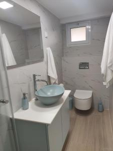 a bathroom with a bowl sink and a toilet at Emilie Guest House in Haifa +3 photos