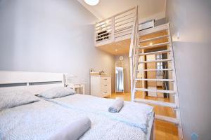 a bedroom with a bunk bed and a ladder at Saltic Deluxe Apartment by 3City Rentals in Sopot