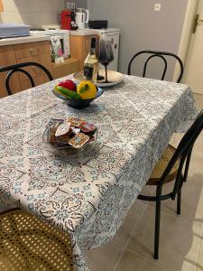 a table with a bowl of fruit on top of it at nikol_house in Alepou