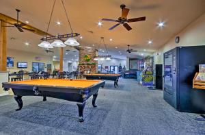 a billiard room with two pool tables in it at Cozy Top Floor 2BR Condo with View and Amenities!! in Branson