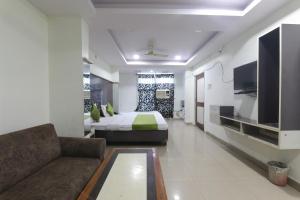 a hotel room with a bed and a couch at Hotel Dayal in Lucknow