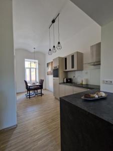 a kitchen and living room with a table with a plate of food at Apartment CITY Ostrava in Moravská Ostrava