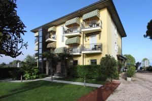 a yellow building with balconies on the side of it at Hotel Campanello in Castelnuovo del Garda