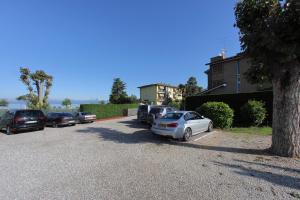 a group of cars parked in a parking lot at Hotel Campanello in Castelnuovo del Garda