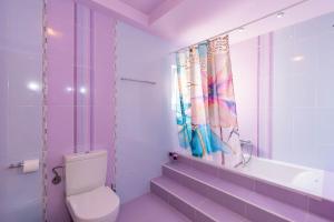 a purple bathroom with a toilet and a sink at BLACK & WHITE CITY VILLA in Alexandroupoli +33 photos