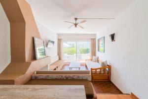 a living room with a staircase with a couch at Atlas Apartments Ibiza in Santa Eularia des Riu +72 photos