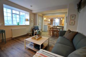 un salon avec un canapé et une table dans l'établissement Sea Holly Cottage- coastal retreat Pittenweem, à Pittenweem
