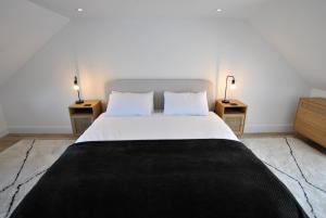 a bedroom with a large bed with two night stands at Crows Neuk- fabulous coastal family home in Saint Monance