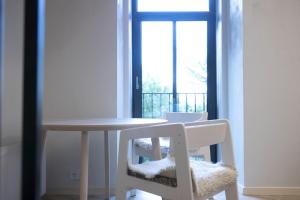 a table and two chairs with a table and a window at Sniego Apartments in Vilnius