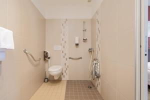 a bathroom with a toilet and a shower at Hotel De L'Agriculture - 2 étoiles in Saint-Hilaire-du-Harcouët