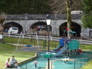a playground with a slide in a park at Appartement T2 eaux-bonnes in Eaux-Bonnes