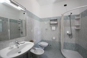 a bathroom with a sink and a toilet and a shower at Hotel Campanello in Castelnuovo del Garda