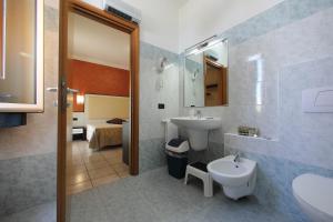 a bathroom with a sink and a toilet at Hotel Campanello in Castelnuovo del Garda