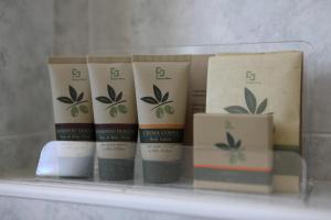 a group of four products sitting on a shelf at Hotel Campanello in Castelnuovo del Garda