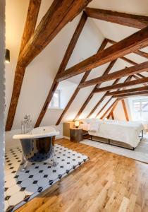 a bathroom with a bath tub in a attic at Domus Balthasar Boutique Hotel in Prague