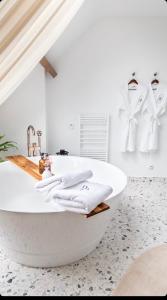 a white bathroom with a bath tub and towels at LA GRANDE MAISON LGM in Lesches +47 photos