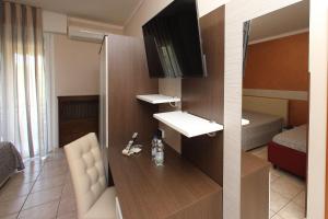 a small room with a sink and a bedroom at Hotel Campanello in Castelnuovo del Garda