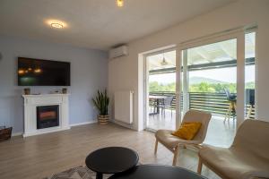 a living room with a couch and a fireplace at Plum house - villa with pool in Gospić