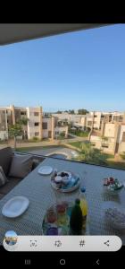 a view of a table with food on a balcony at Superbe appartement luxueux idéalement situé à la marina saidia in Saïdia