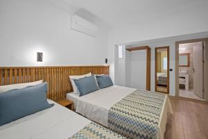 a bedroom with two beds and a mirror at Costa Viva Bodrum in Bodrum City