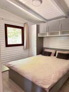 a bedroom with a large bed and a window at Cabana Sia in Sibiu