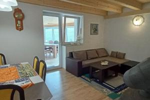 a living room with a couch and a table at Sunny House in Netolice