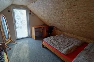 a bedroom with a bed and a large window at Sunny House in Netolice