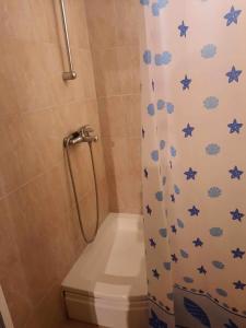 a shower with a shower curtain with blue stars on it at Apartments Stars in Ohrid