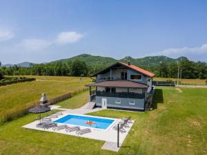 an aerial view of a house with a swimming pool at Plum house - villa with pool in Gospić