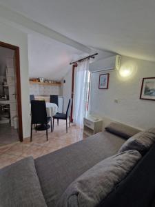 a bedroom with a bed and a table and chairs at Old town - AP3 in Tribunj
