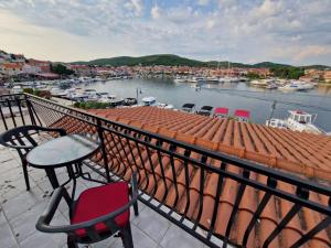 a balcony with a table and chairs and a marina at Old town - AP3 in Tribunj