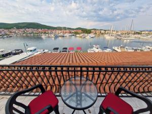 a table and chairs on a balcony with a marina at Old town - AP3 in Tribunj