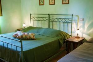 a bedroom with a bed and a table with a lamp at Agriturismo Ca'Mazzetto in Valfabbrica