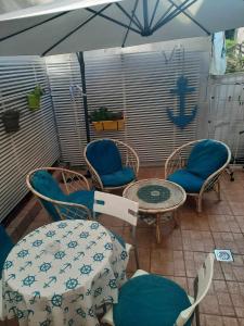 a patio with chairs and tables and an umbrella at Apartments Stars in Ohrid