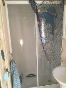 a bathroom with a shower with a net at Lakeland Retreat in Lamplugh