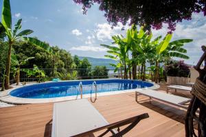 a swimming pool in the middle of a wooden deck at Vila Oliva in Herceg-Novi
