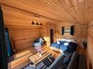 an overhead view of a log cabin with a bed and a table at Alone Cottage Kazbegi in Stepantsminda