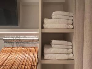 een kast met witte handdoeken in de badkamer bij Luxe appartement met adembenemend uitzicht op zee in Oostende