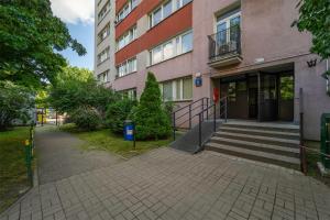 a building with a staircase in front of a building at Metro Dworzec Gdański Standard Studio in Warsaw