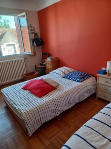 a bedroom with a large bed and a window at Entre Loire et canal in Briare